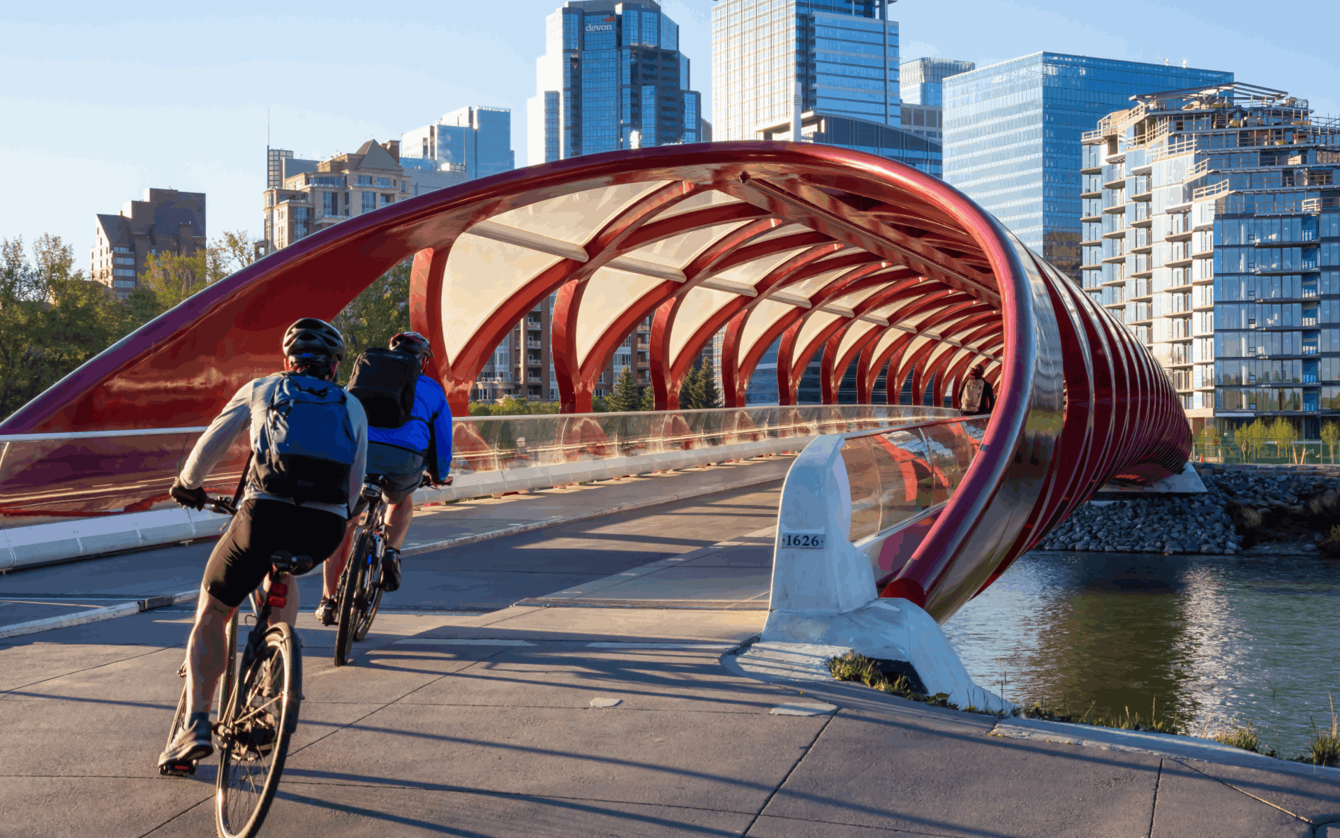 Two cyclists crossing Peace Bridge in Calgary Alberta